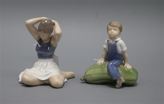 A Royal Copenhagen model of a seated ballerina, number 4648, and another of a boy sitting on a gourd, number 4539 tallest 12cm